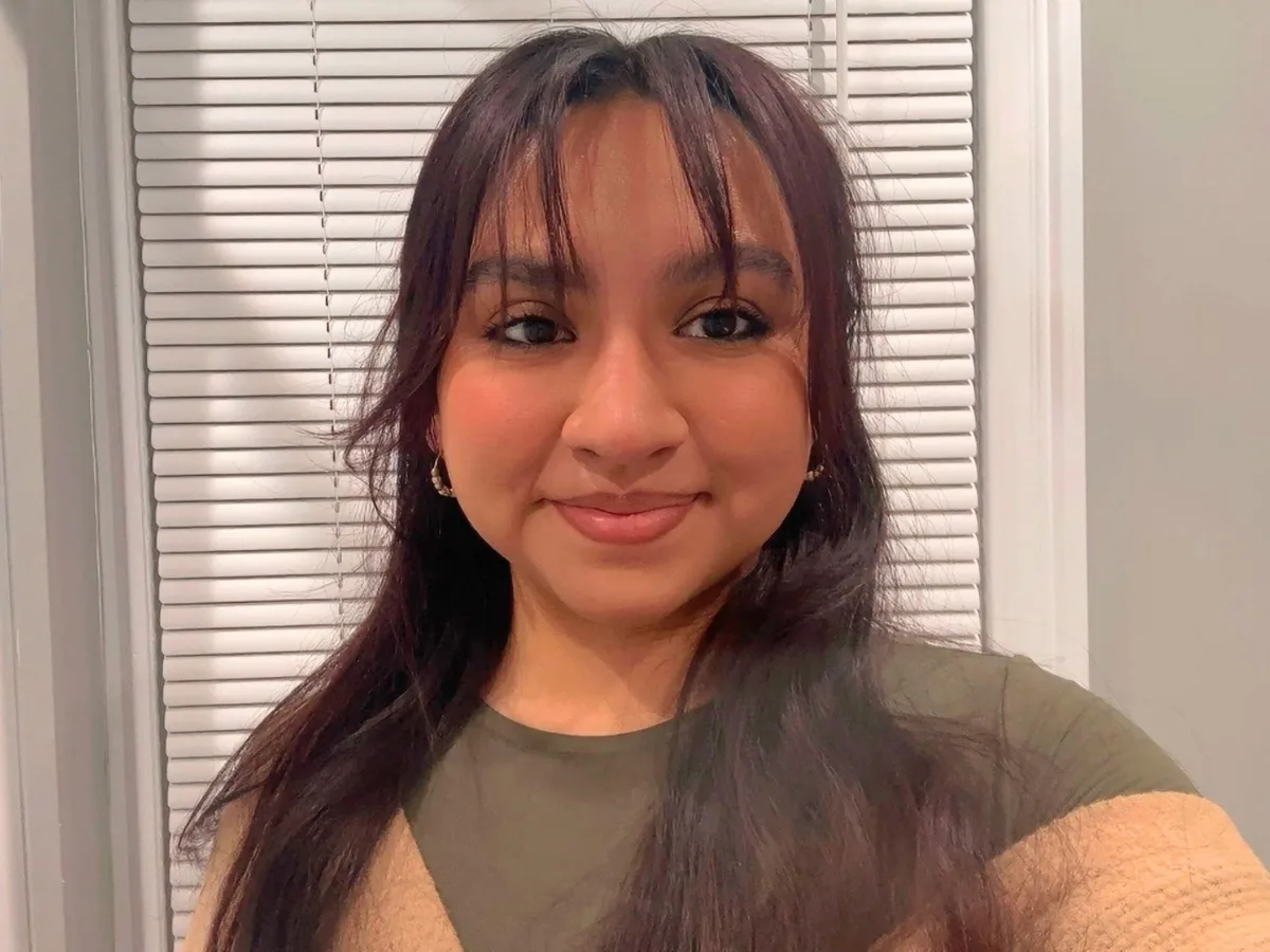 Scholar Delania taking a selfie portrait smiling at the camera